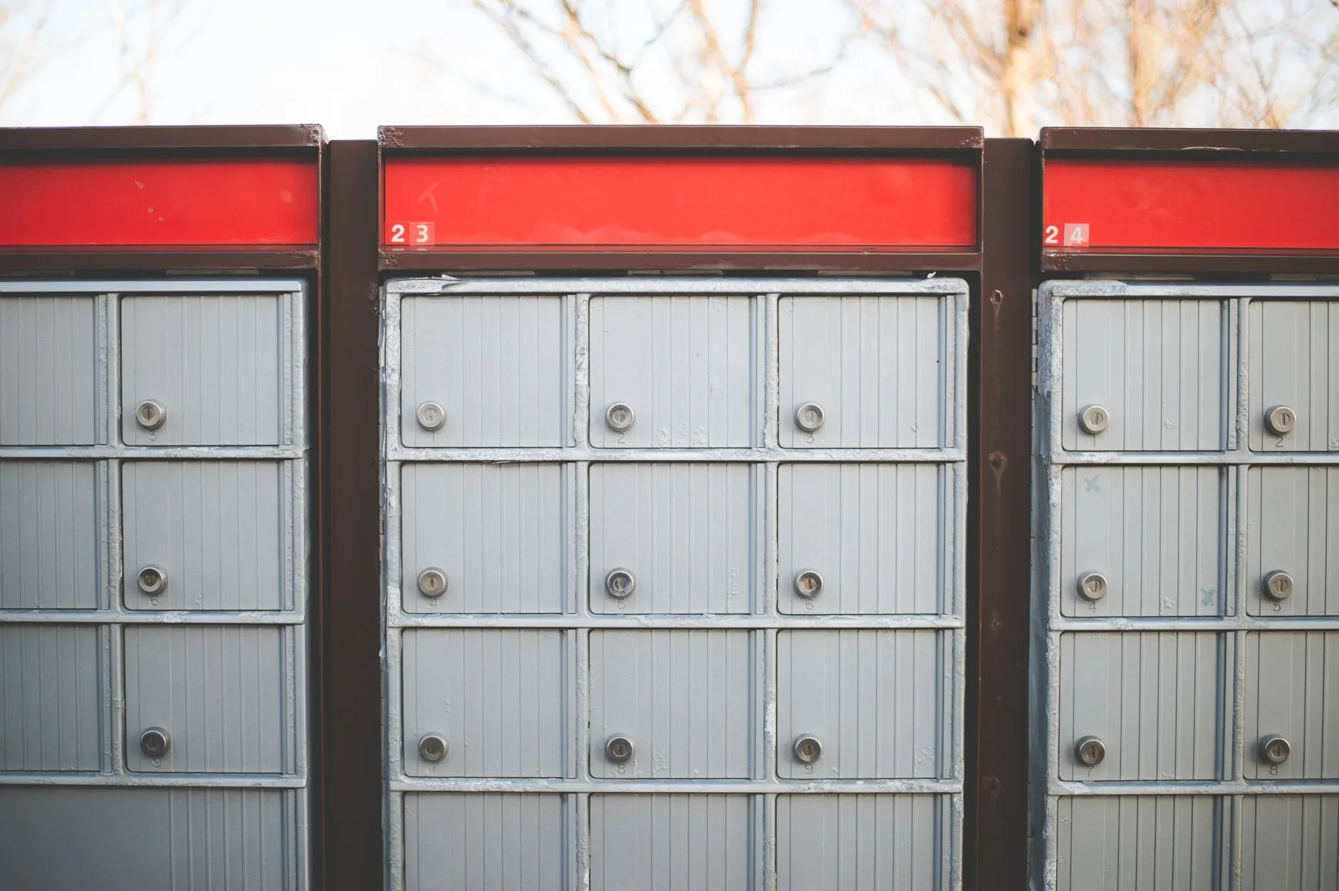 Secure outdoor community mailboxes with individual locked compartments.