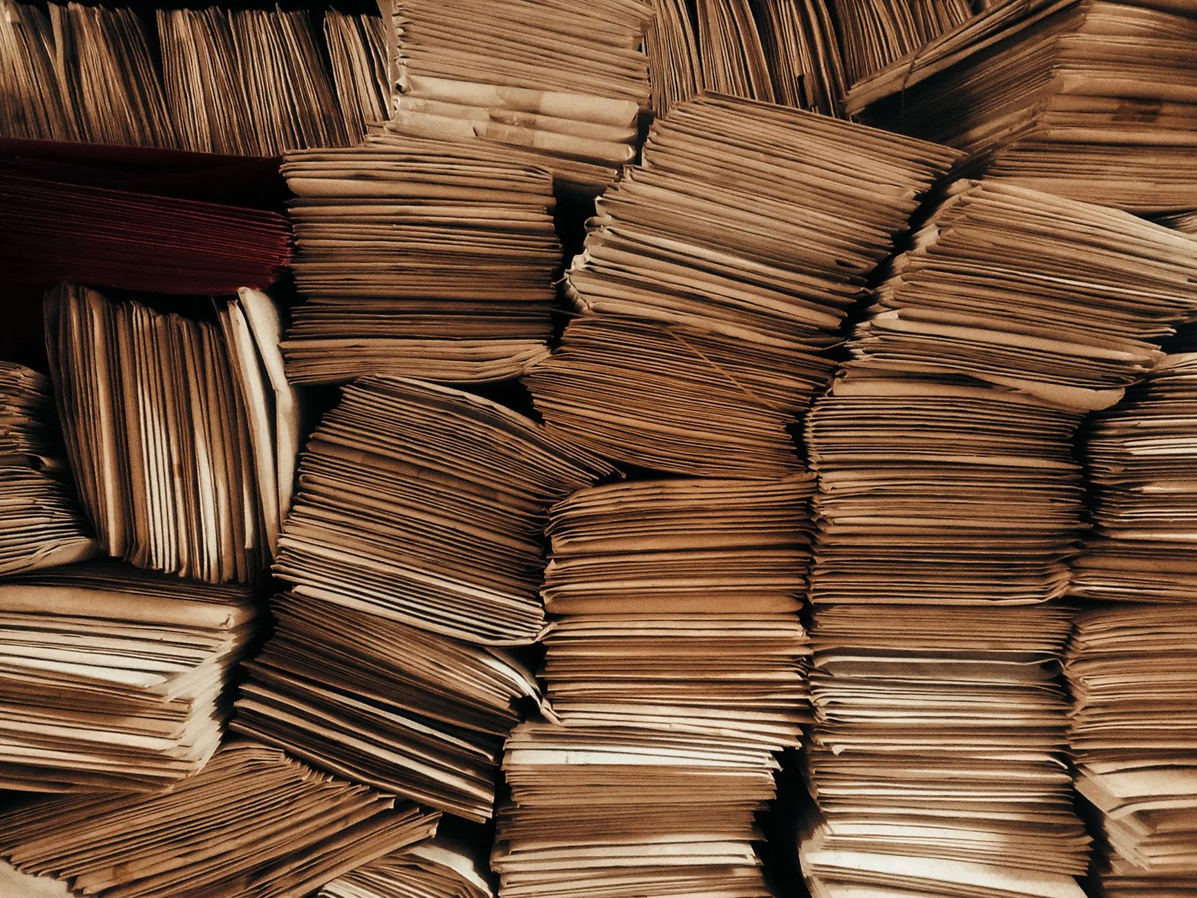 A detailed view of neatly stacked brown envelopes.