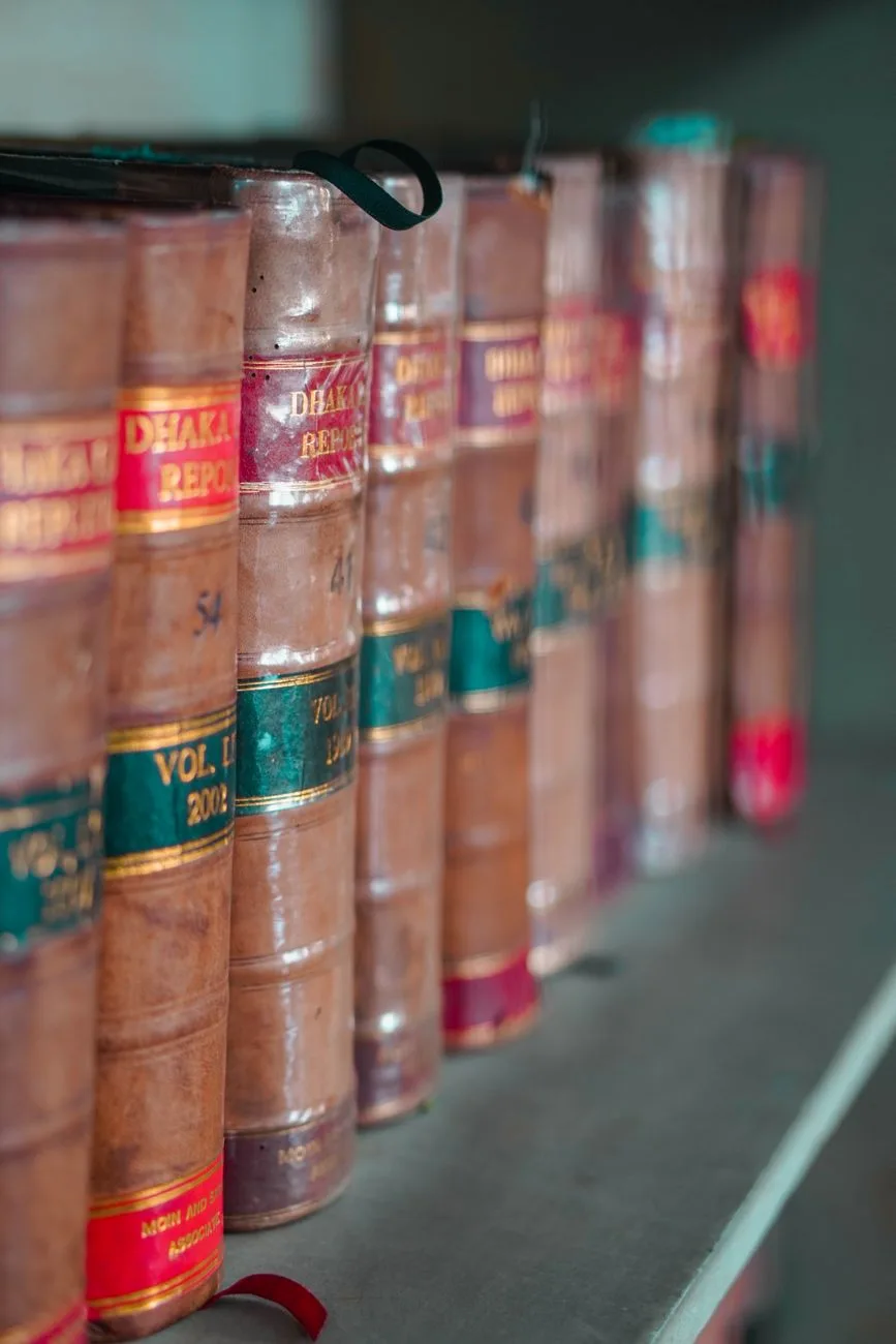 Leather-bound law books arranged neatly on a bookshelf.