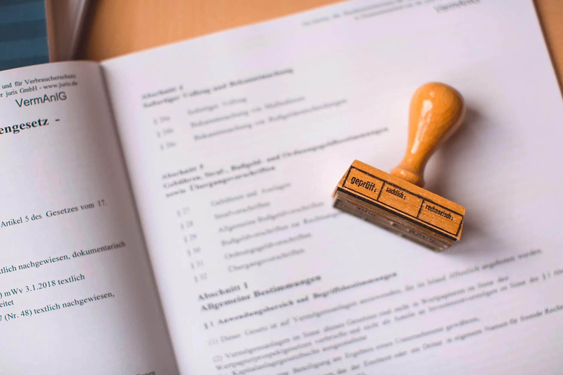 A wooden stamp resting on an open legal document.