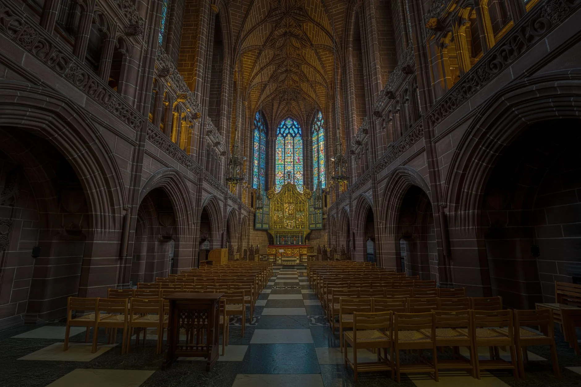 A majestic Gothic cathedral interior with stained glass windows.
