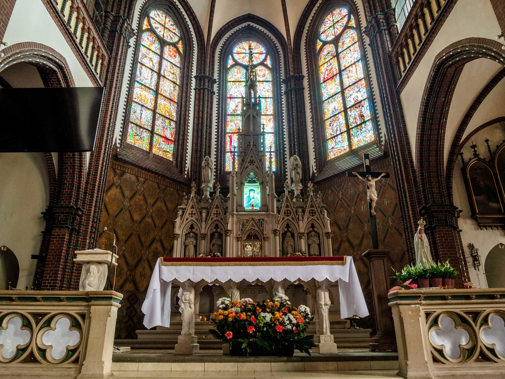 A Gothic church altar adorned with stained glass and intricate designs.