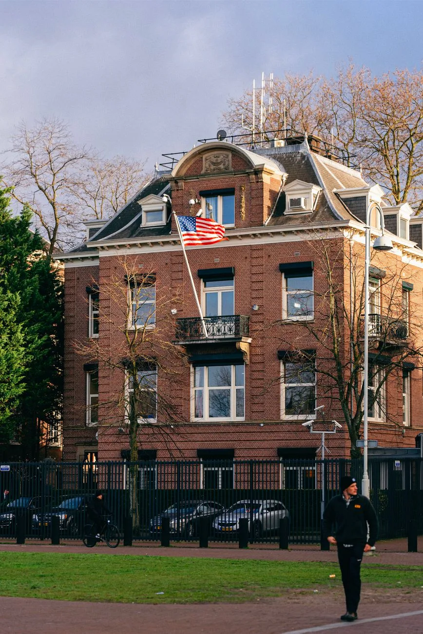 A grand historic building adorned with the US flag.