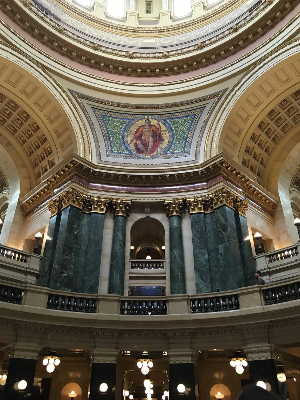 The ornate interior dome of a state capitol rotunda.