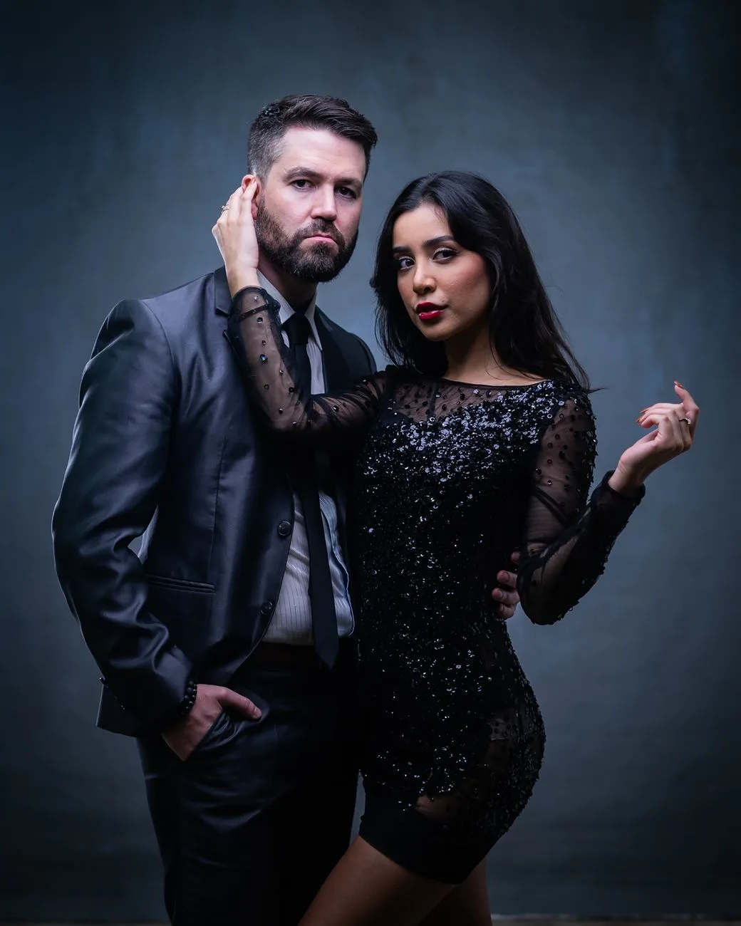 A stylish portrait of a couple in elegant evening wear.