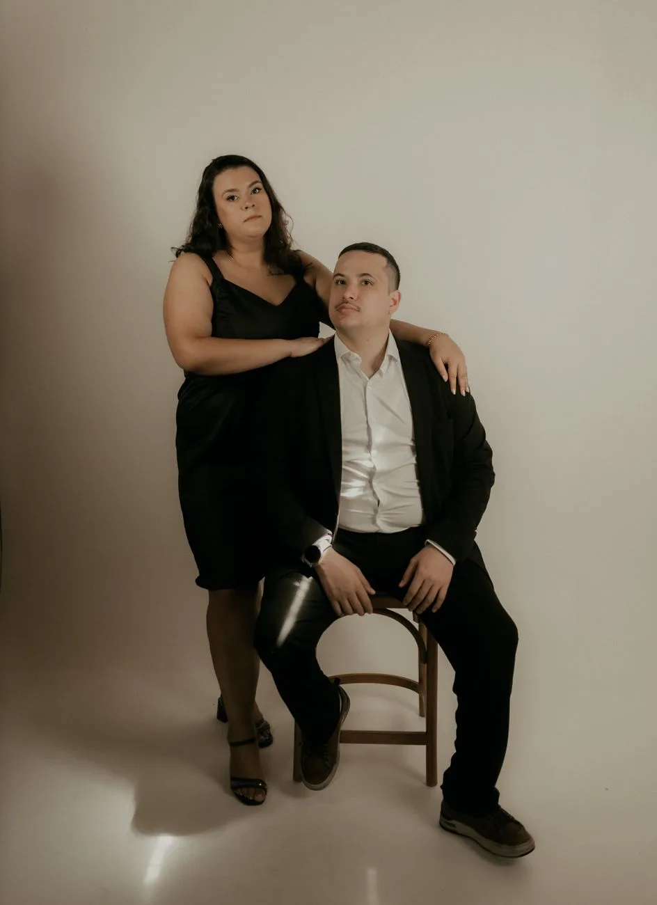 A sophisticated portrait of a couple in formal attire.