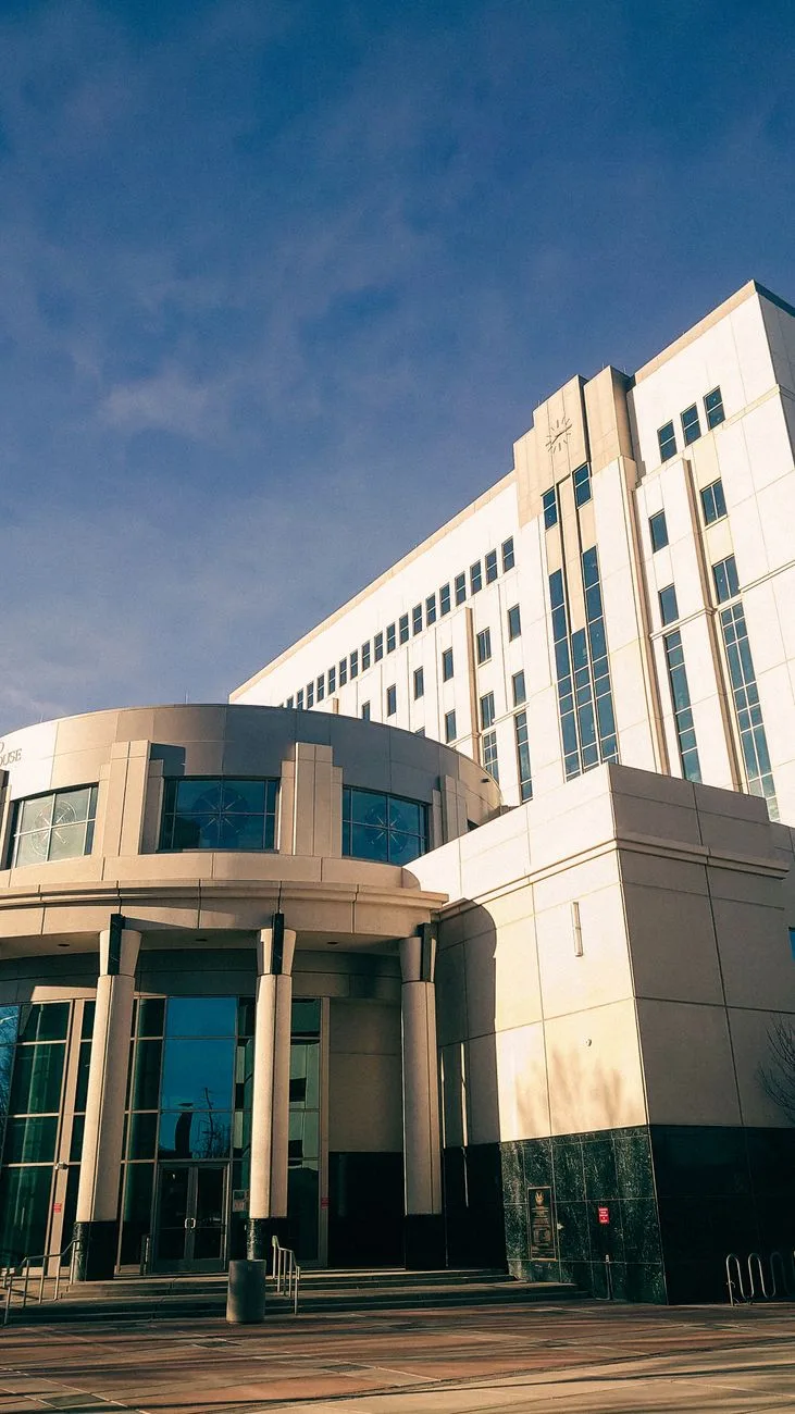 A modern courthouse building against a clear blue sky.