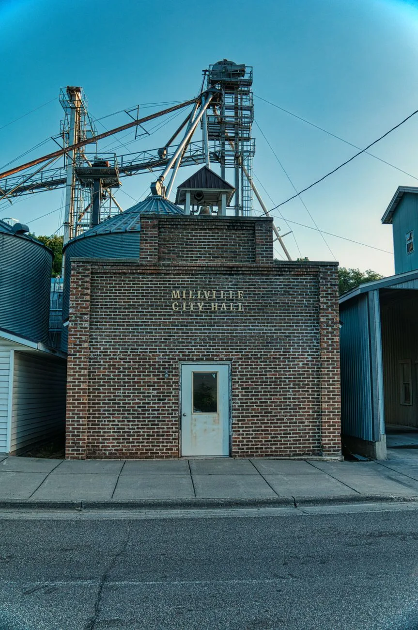 The brick facade entrance of a small city hall building.