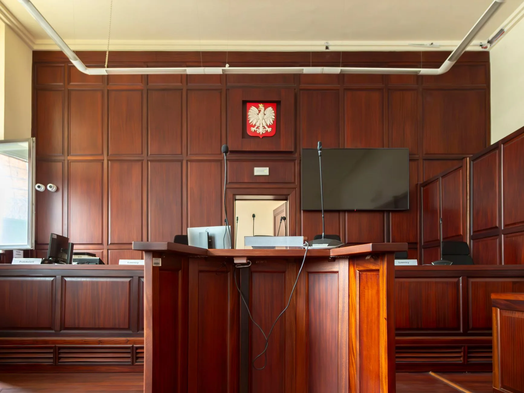 The elegant wooden interior of a small courtroom.