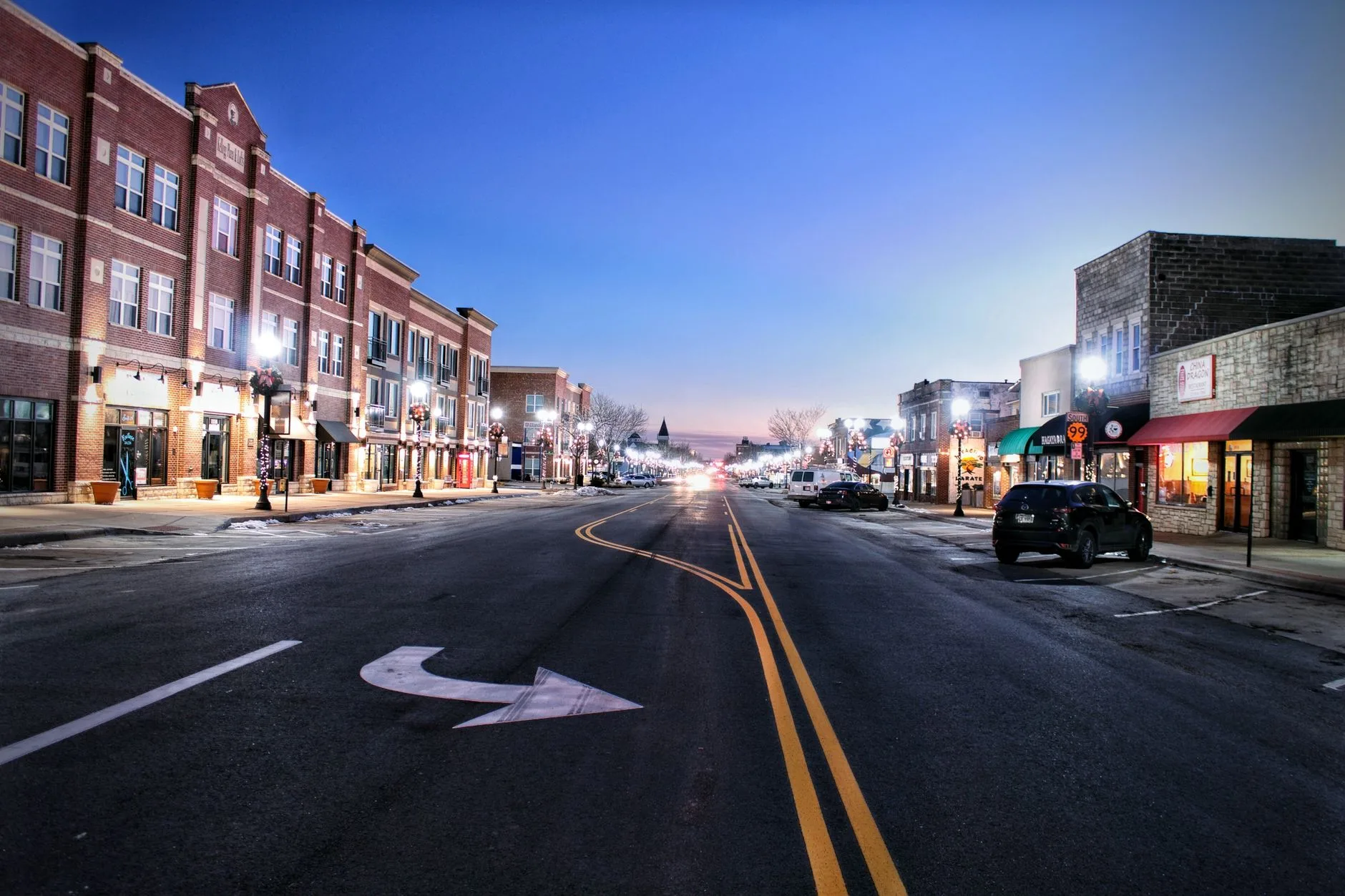 A quiet Main Street in a small city at twilight.