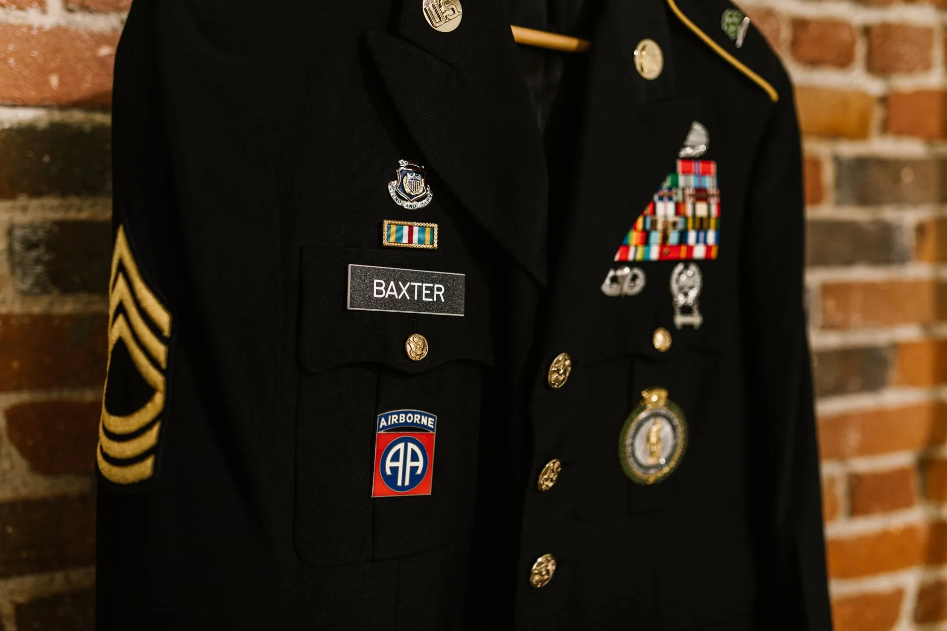 A close-up of a decorated military uniform with badges and medals.