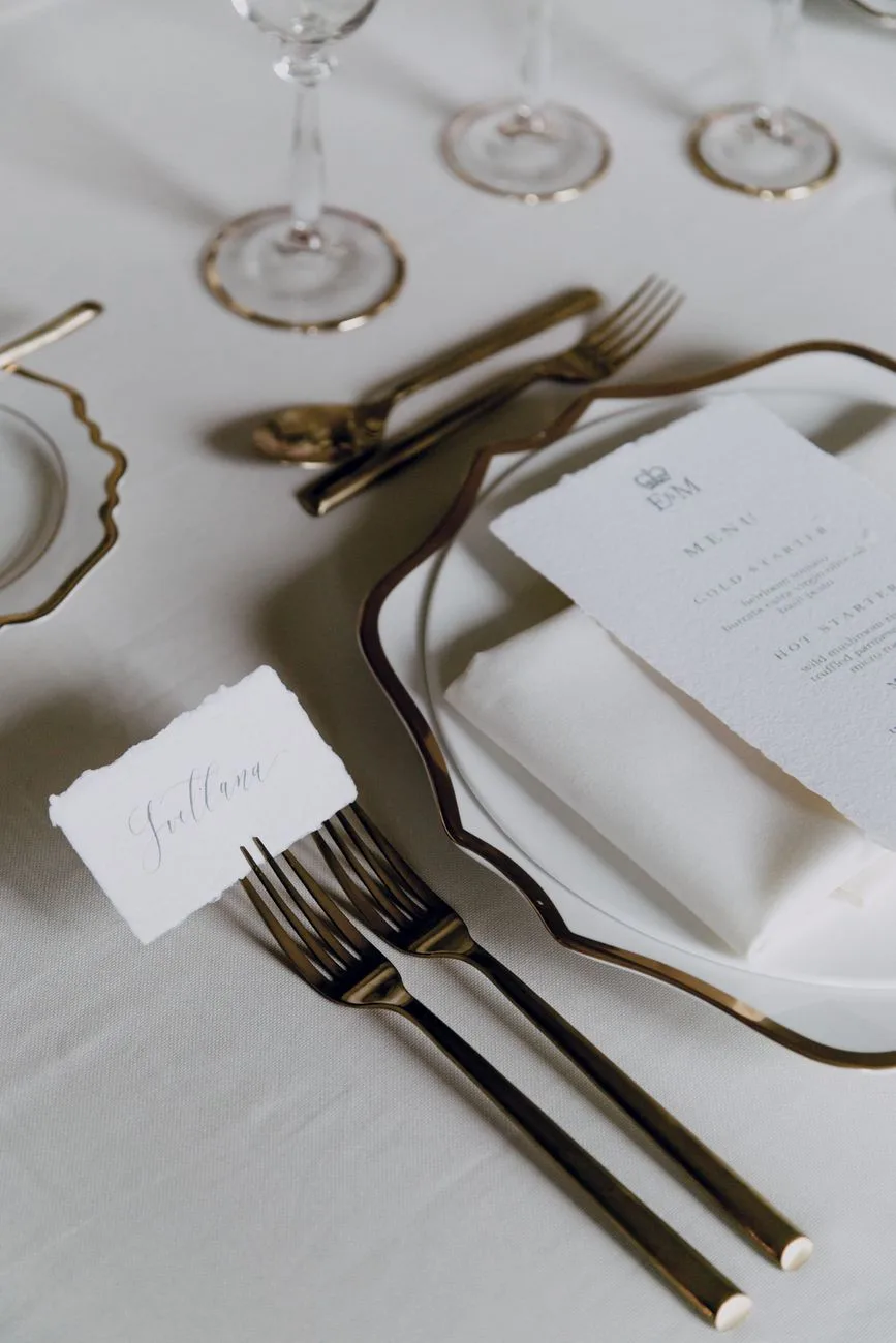 Elegant cutlery and wine glasses on a formal dinner table.