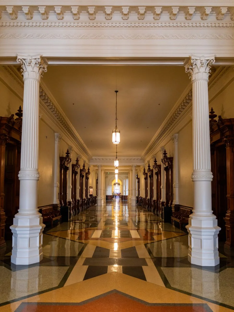 An elegant marble corridor inside a state capitol building.