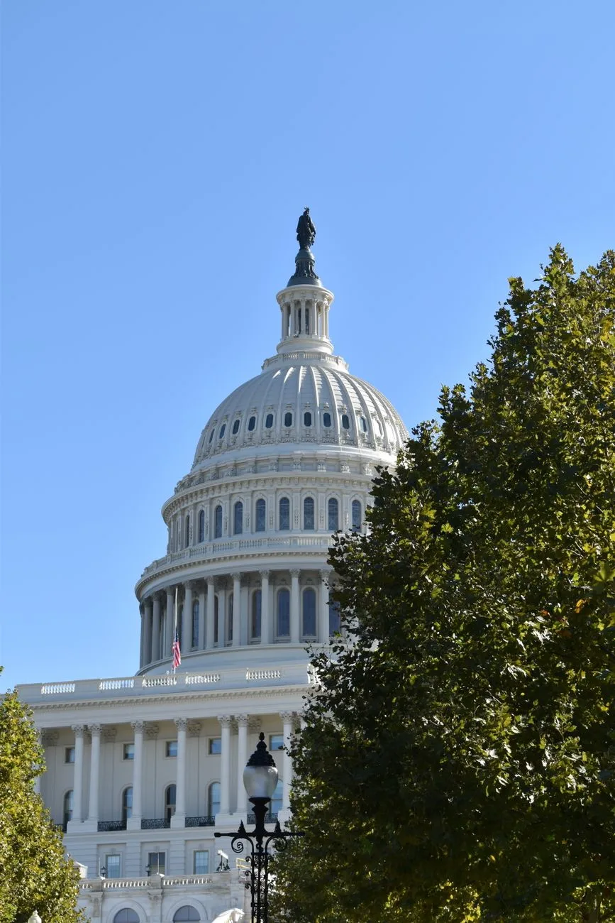 The United States Capitol Building under a clear blue sky.