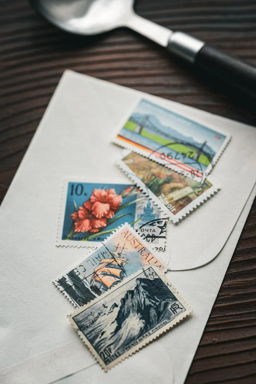 An aesthetic flat lay of vintage stamps on an envelope with a wooden background.