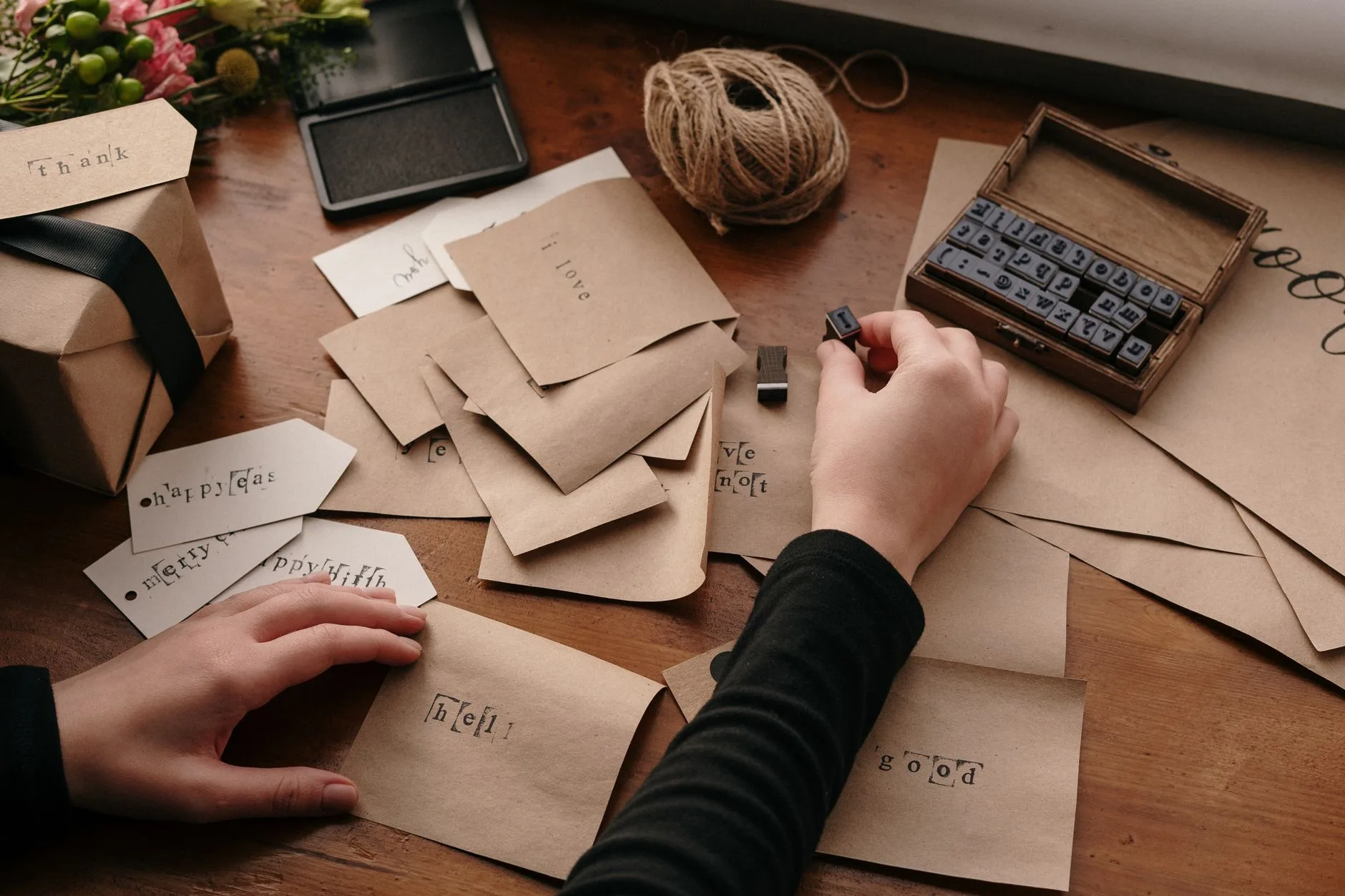 A person stamping handmade Christmas cards.