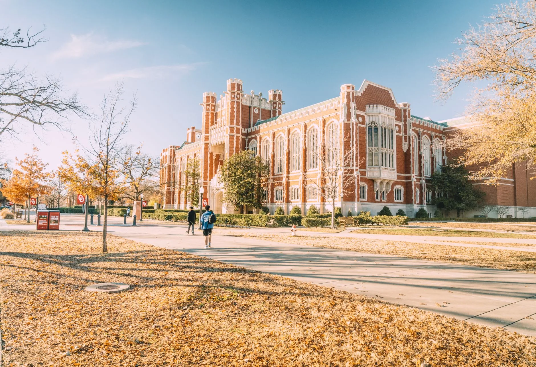 A scenic view of a historic university building surrounded by autumn foliage.
