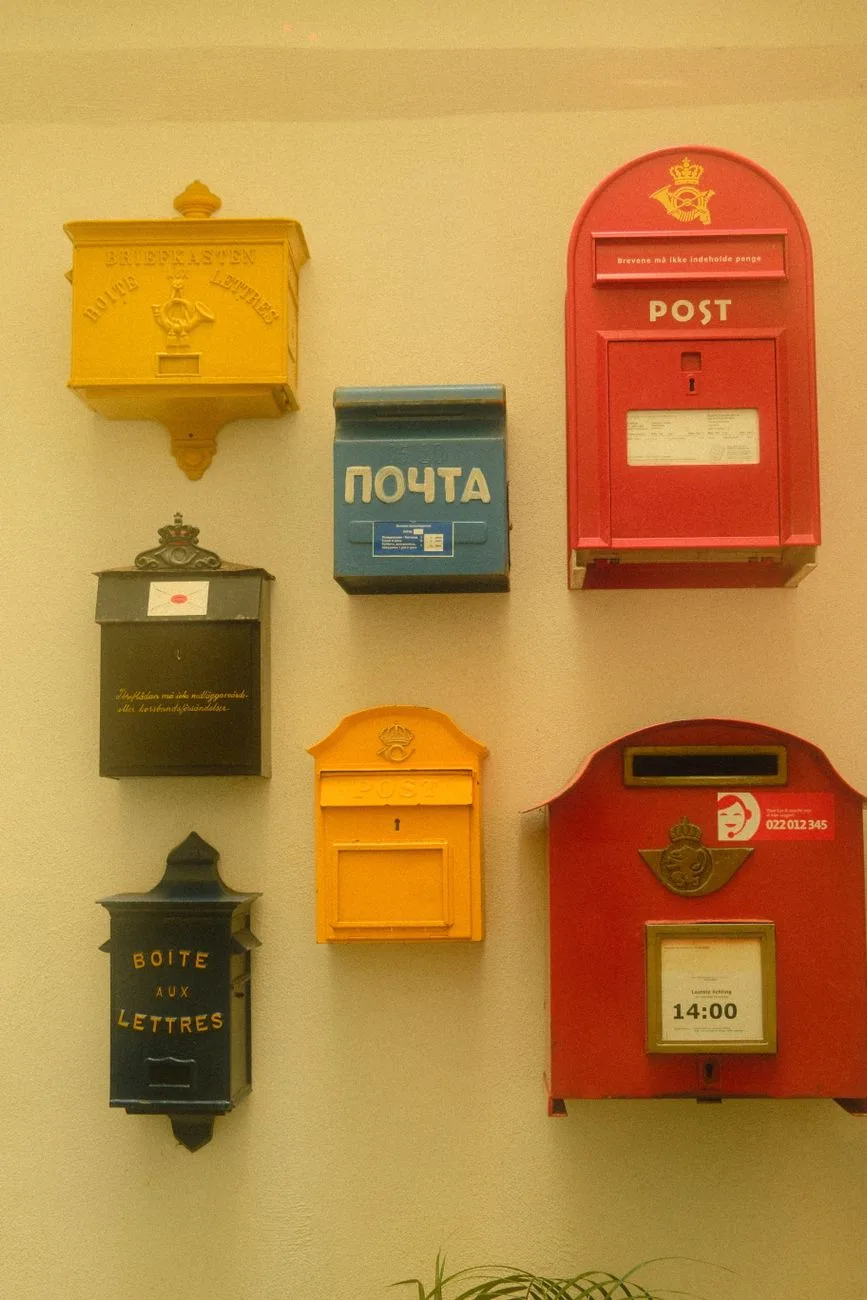A collection of colorful vintage mailboxes in different styles.