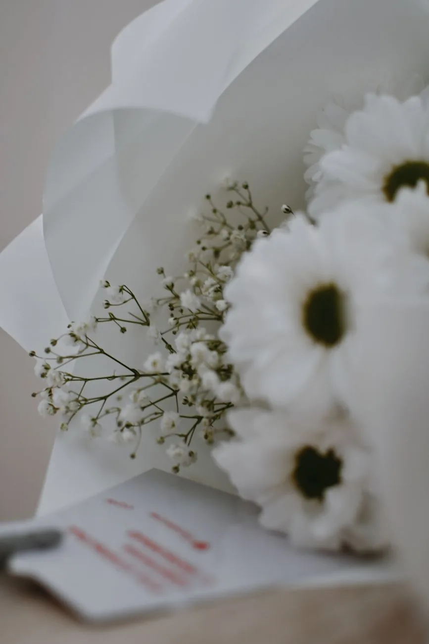 A soft-focus image of a white floral bouquet with delicate blossoms.