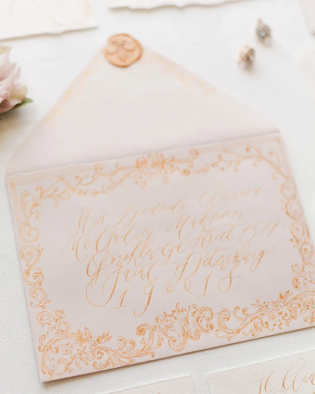 A beautifully designed wedding invitation envelope with intricate calligraphy.